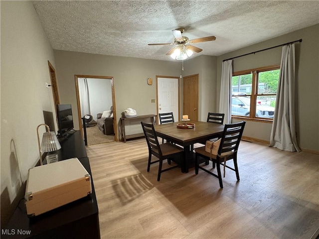 11153 Pleasant Rd, Pleasant City, OH 43772 - dining area with ceiling fan, light wood finished floors, a textured ceiling, and baseboards