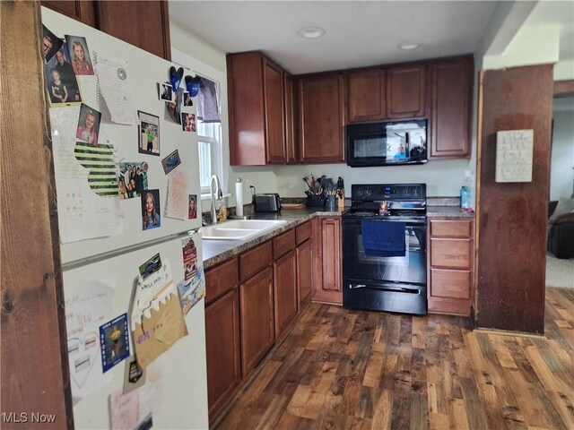 1327 Orange St, Coshocton, OH 43812 - kitchen with black appliances, a sink, dark wood finished floors, recessed lighting, and dark countertops