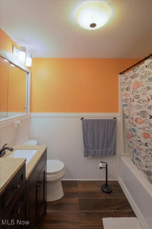 31 Garden Park Dr, Chagrin Falls, OH 44022 - full bath with wood finished floors, a wainscoted wall, vanity, toilet, and shower / bath combo