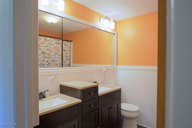 31 Garden Park Dr, Chagrin Falls, OH 44022 - bathroom with wainscoting, toilet, and double vanity