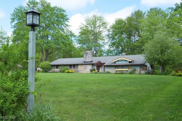 31 Garden Park Dr, Chagrin Falls, OH 44022 - view of front of house with a front lawn, a chimney, and stone siding