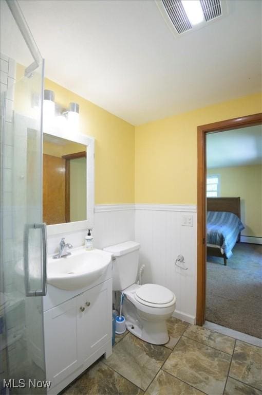 31 Garden Park Dr, Chagrin Falls, OH 44022 - bathroom featuring vanity, toilet, a stall shower, and a wainscoted wall