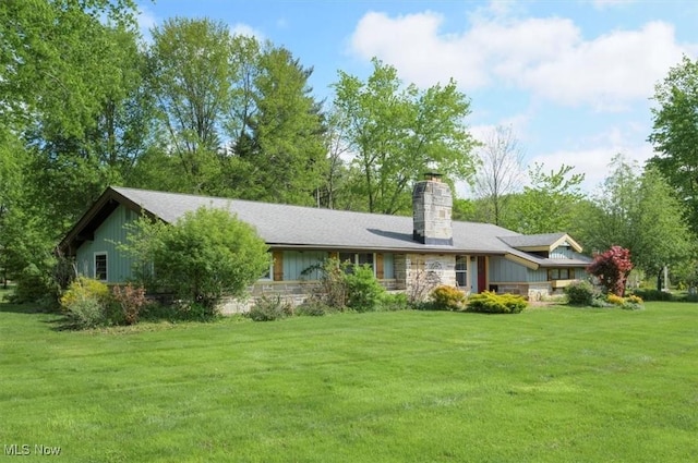 31 Garden Park Dr, Chagrin Falls, OH 44022 - back of house featuring a chimney, a lawn, board and batten siding, and stone siding