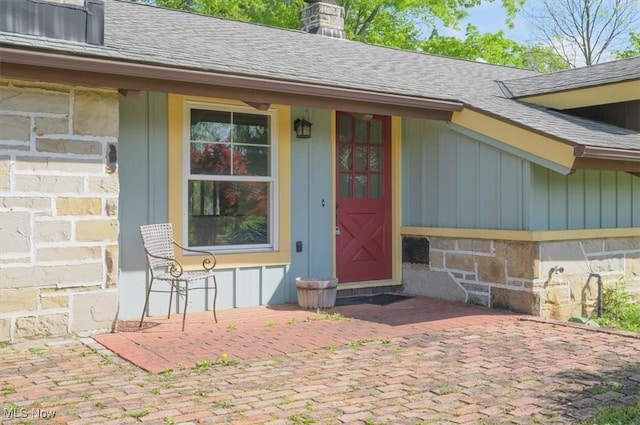 31 Garden Park Dr, Chagrin Falls, OH 44022 - property entrance with a shingled roof, board and batten siding, and a porch