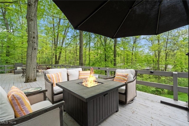 540 Bent Creek Oval, Aurora, OH 44202 - deck with an outdoor fire pit and a view of trees