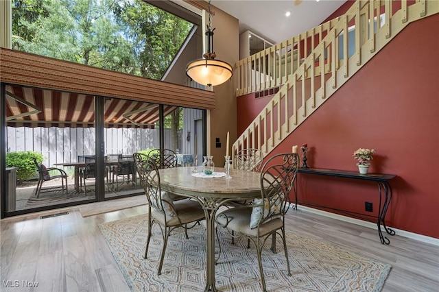 540 Bent Creek Oval, Aurora, OH 44202 - dining area with wood finished floors, stairs, baseboards, and a towering ceiling