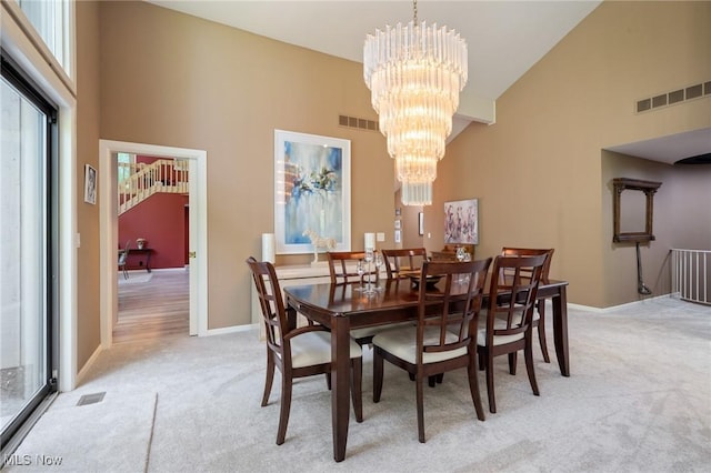 540 Bent Creek Oval, Aurora, OH 44202 - dining room with high vaulted ceiling, light carpet, a chandelier, and baseboards