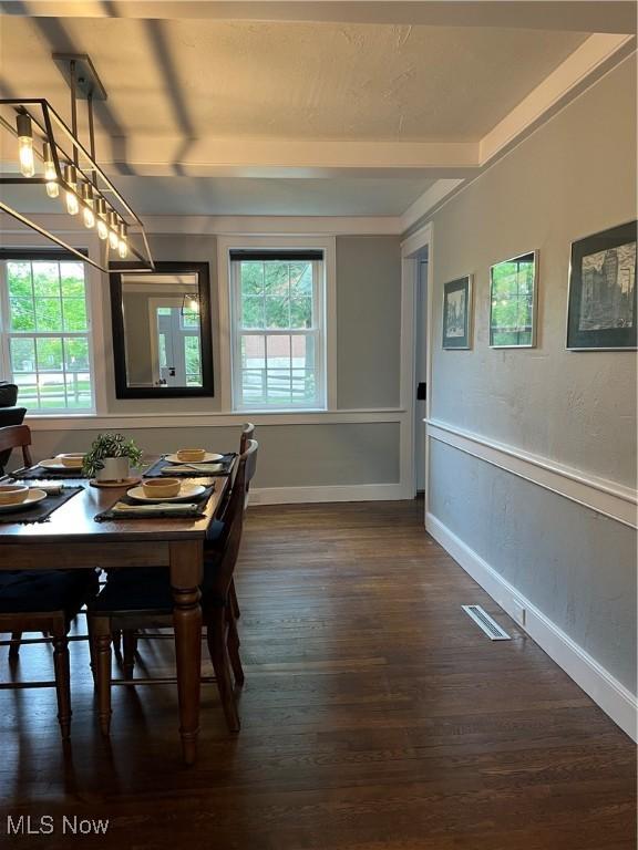 dining room with plenty of natural light, dark wood-style floors, and baseboards