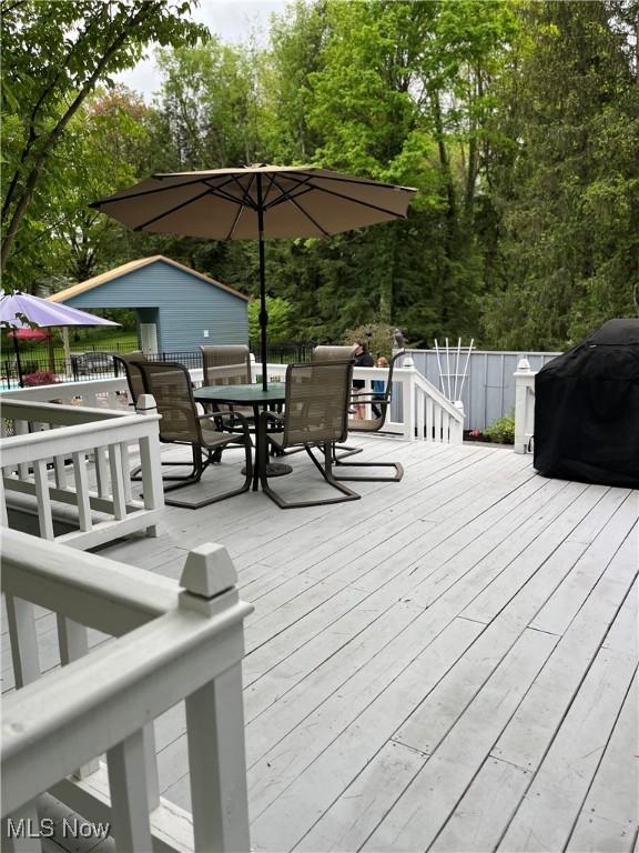 deck featuring outdoor dining area and area for grilling