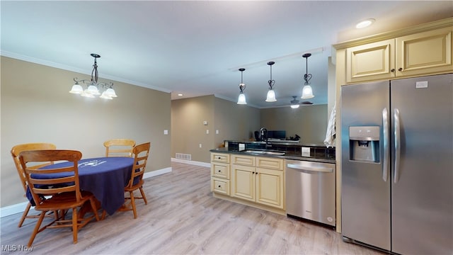 416 Elm St Unit B, Belpre, OH 45714 - kitchen with cream cabinets, stainless steel appliances, dark countertops, ornamental molding, and baseboards