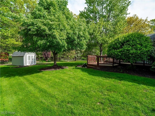 21428 Montclare Blvd, Strongsville, OH 44149 - view of green lawn featuring a storage shed, a wooden deck, and an outbuilding