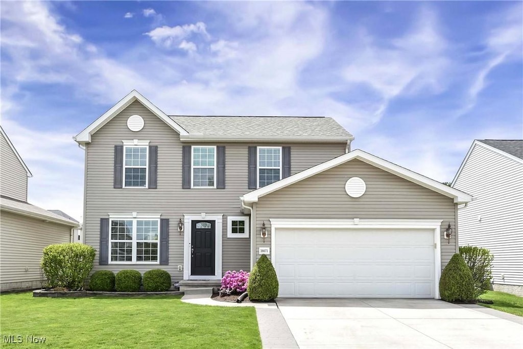 38071 Rocky Run Ct, North Ridgeville, OH 44039 - view of front of property with a garage, concrete driveway, and a front yard
