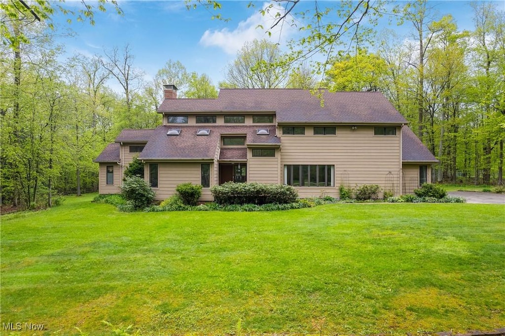 8880 Galloway Trl, Novelty, OH 44072 - back of property with a chimney, a yard, and a shingled roof