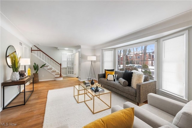 2400 Saybrook Rd, University Heights, OH 44118 - living area featuring stairs, light wood-style flooring, and baseboards
