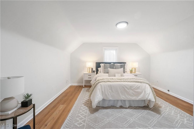 2400 Saybrook Rd, University Heights, OH 44118 - bedroom featuring wood finished floors, lofted ceiling, and baseboards