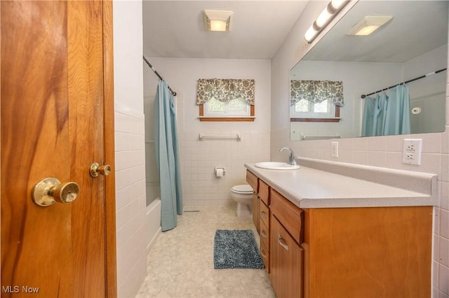 1655 Calder Ridge Rd, Belpre, OH 45714 - bathroom with tile walls, toilet, vanity, and wainscoting