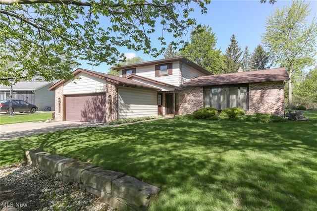view of front of home with brick siding, an attached garage, concrete driveway, and a front yard