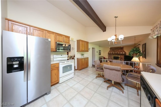 kitchen featuring stainless steel appliances, a chandelier, open floor plan, light countertops, and brown cabinets