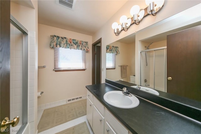 full bathroom with an enclosed shower, vanity, tile patterned floors, and baseboards
