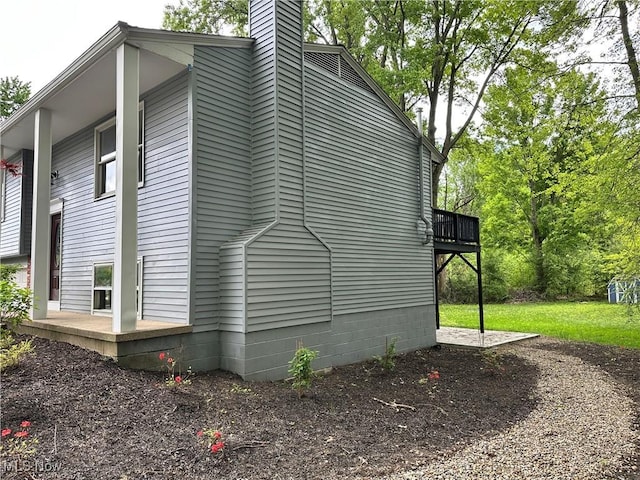9744 Andrea Dr, Concord, OH 44060 - view of side of property with a chimney and a deck