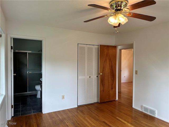 9744 Andrea Dr, Concord, OH 44060 - unfurnished bedroom featuring wood finished floors, a closet, baseboards, connected bathroom, and a ceiling fan