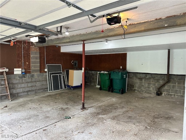 9744 Andrea Dr, Concord, OH 44060 - garage with a garage door opener and concrete block wall