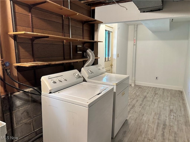 9744 Andrea Dr, Concord, OH 44060 - laundry room with light wood finished floors, baseboards, and washer and clothes dryer
