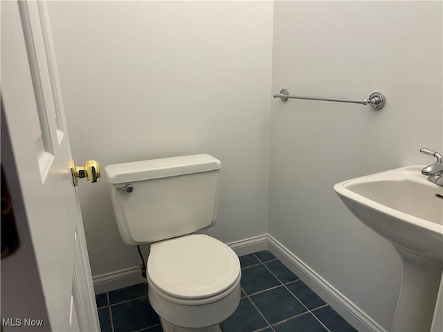 9744 Andrea Dr, Concord, OH 44060 - half bathroom with toilet, tile patterned floors, a sink, and baseboards