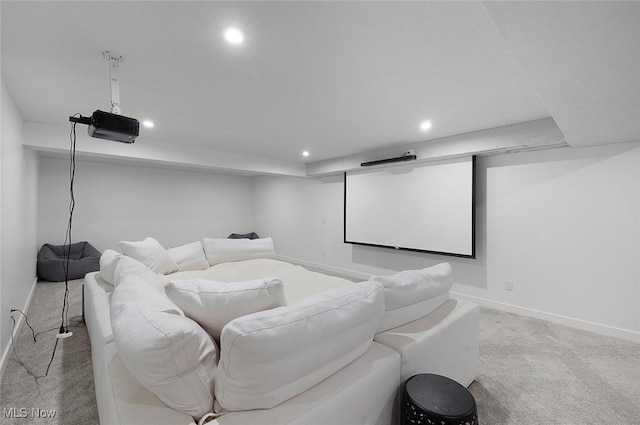 home theater room featuring light colored carpet, recessed lighting, and baseboards