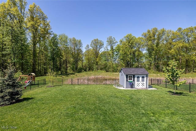 view of yard featuring a storage shed, an outbuilding, and a playground