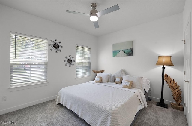 carpeted bedroom featuring baseboards and a ceiling fan