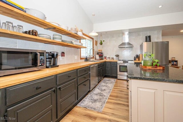 8584 Fisher Rd, Diamond, OH 44412 - kitchen with stainless steel appliances, open shelves, a sink, wall chimney range hood, and tasteful backsplash