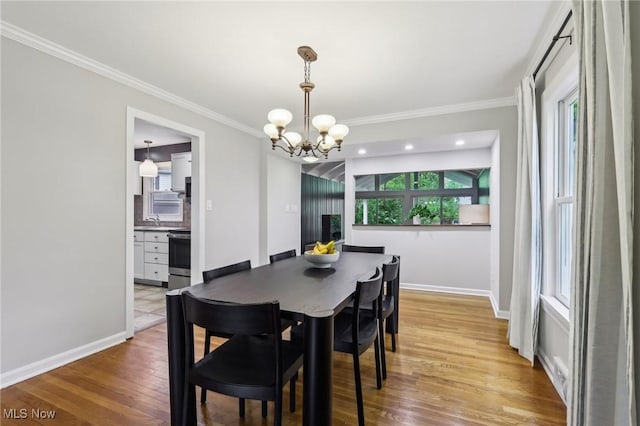 22650 Westchester Rd, Shaker Heights, OH 44122 - dining room featuring ornamental molding, a chandelier, light wood-type flooring, and baseboards