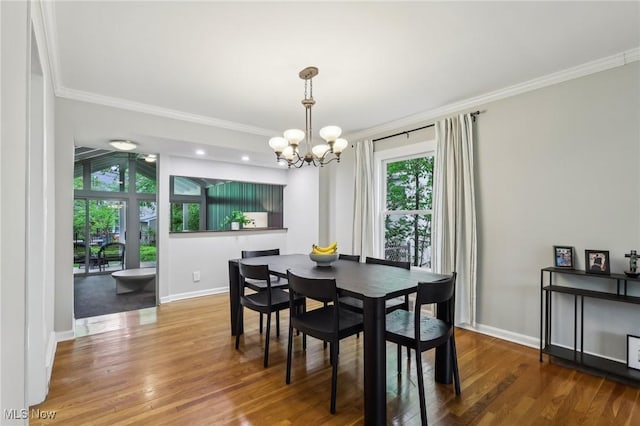 22650 Westchester Rd, Shaker Heights, OH 44122 - dining area featuring crown molding, a chandelier, wood finished floors, and baseboards