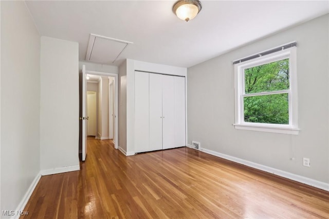 22650 Westchester Rd, Shaker Heights, OH 44122 - unfurnished bedroom featuring attic access, wood finished floors, a closet, and baseboards