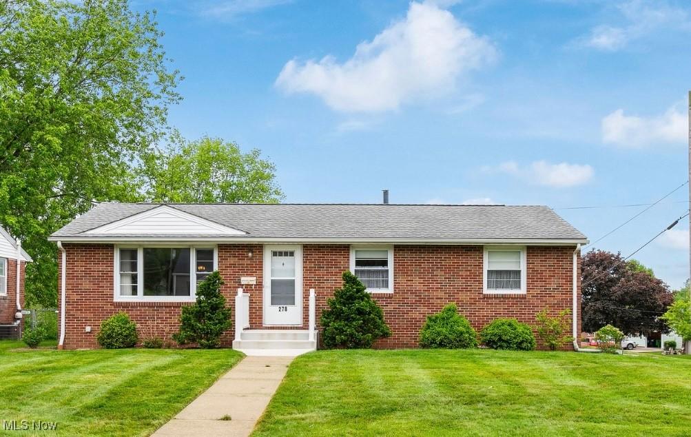 278 25th St NW, Massillon, OH 44647 - view of front facade with a front lawn, brick siding, and a shingled roof
