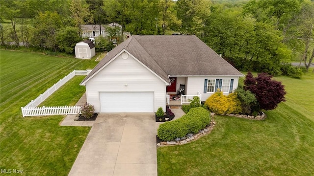 130 Hillside Dr, East Palestine, OH 44413 - view of front of home with an attached garage, driveway, a storage unit, and an outdoor structure