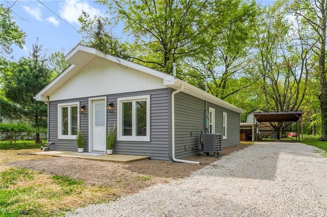 17469 Laurel Ave, Lake Milton, OH 44429 - view of front facade featuring central AC unit, driveway, and a detached carport