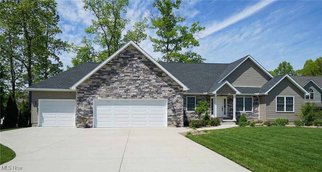 1328 Victory Hill Ln, Austintown, OH 44515 - craftsman inspired home featuring an attached garage, concrete driveway, a front lawn, and stone siding