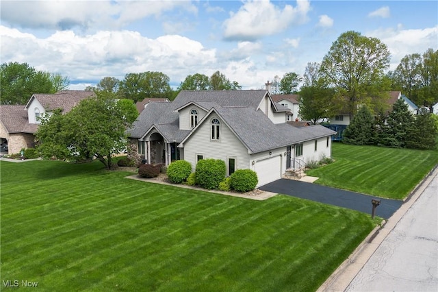 view of front of home with asphalt driveway, a front lawn, an attached garage, and roof with shingles