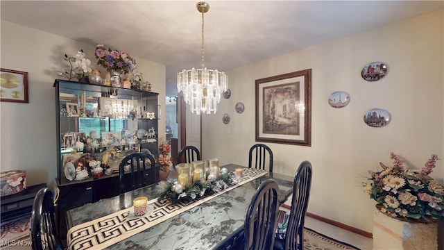 carpeted dining room featuring a chandelier and baseboards