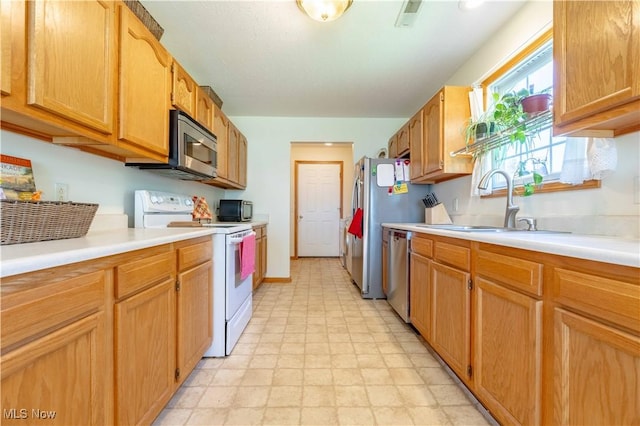 1402 SW Channonbrook St SW, Canton, OH 44710 - kitchen with stainless steel appliances, light countertops, light floors, and brown cabinetry