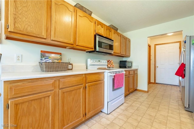 1402 SW Channonbrook St SW, Canton, OH 44710 - kitchen featuring stainless steel appliances, light flooring, and light countertops