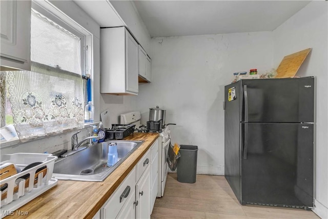 1348 Himrod Ave, Youngstown, OH 44506 - kitchen featuring freestanding refrigerator, gas range gas stove, a sink, and wood counters