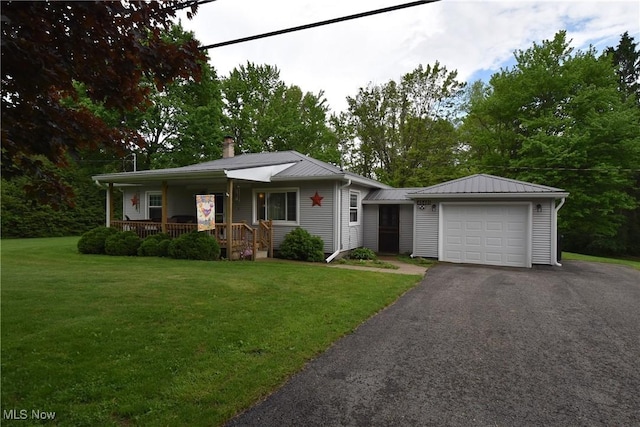 48481 Metz Rd, New Waterford, OH 44445 - view of front facade with a porch, a garage, asphalt driveway, and a front yard