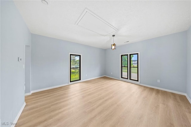 9324 Columbia Rd, Olmsted Falls, OH 44138 - spare room with attic access, light wood-type flooring, and baseboards