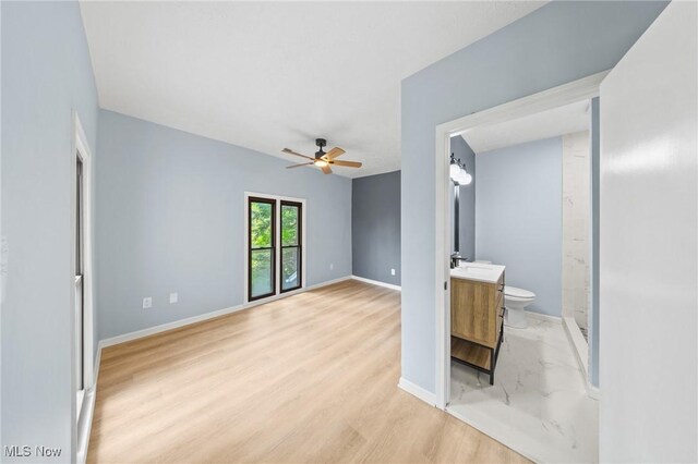 9324 Columbia Rd, Olmsted Falls, OH 44138 - unfurnished living room featuring ceiling fan, baseboards, light wood-style flooring, and a sink