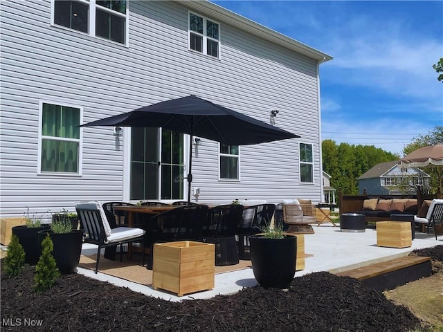 1810 Muirfield Ln, Painesville, OH 44077 - rear view of property featuring a patio area and outdoor lounge area