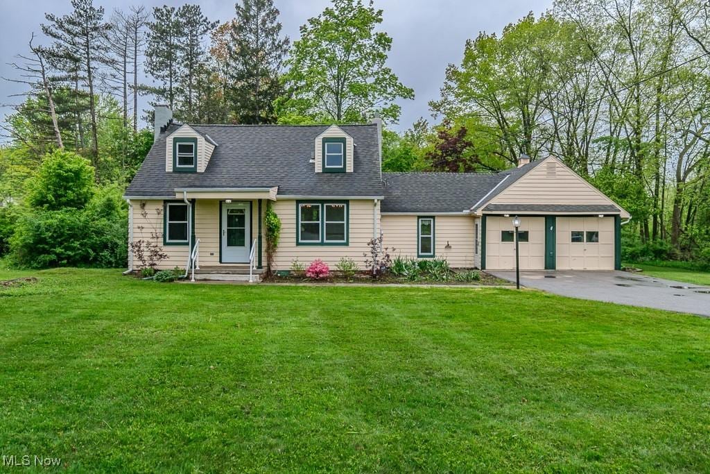 11402 Chillicothe Rd, Chesterland, OH 44026 - cape cod home with an attached garage, a front yard, asphalt driveway, a chimney, and a shingled roof