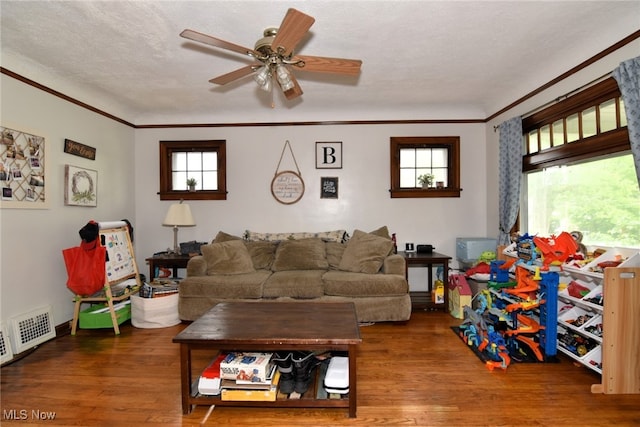 living room featuring ornamental molding, wood finished floors, and ceiling fan